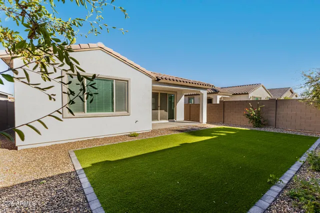 a view of a house with a yard and sitting area