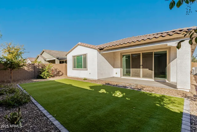 a view of a house with a backyard