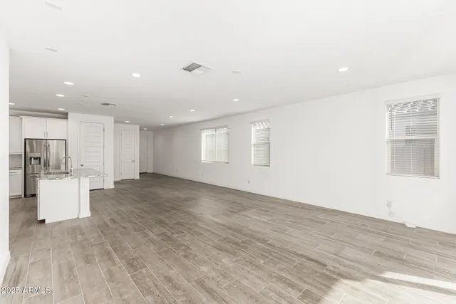 a view of a kitchen with furniture and wooden floor