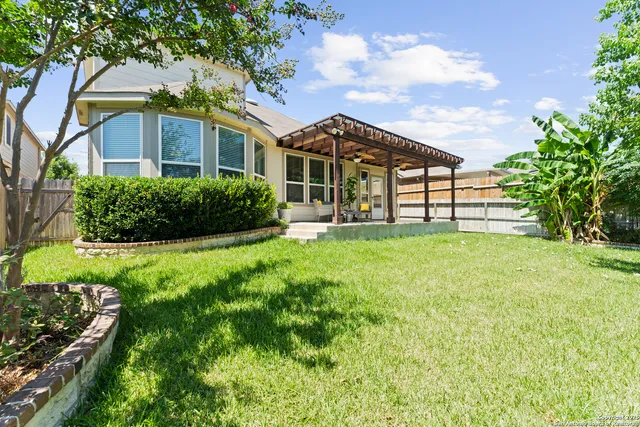 a view of a house with a yard and sitting area