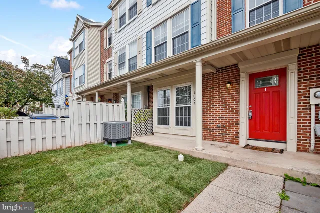 a view of a house with many windows and a yard