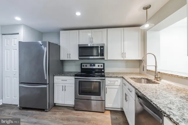 a kitchen with a sink stove and refrigerator