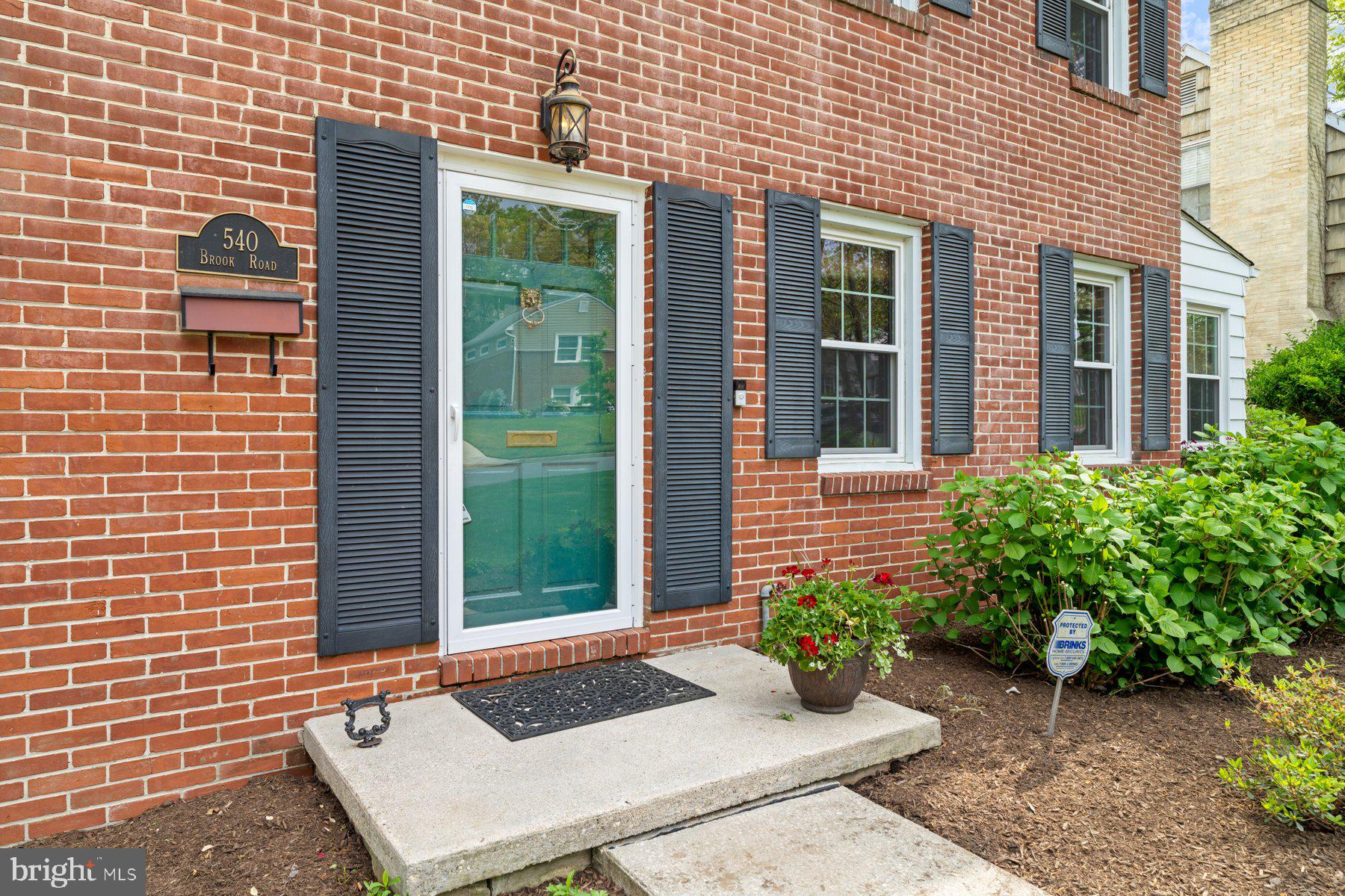 540 Brook Road Towson, MD 21286 - Photo 3 of 37 a view of a brick house with potted plants