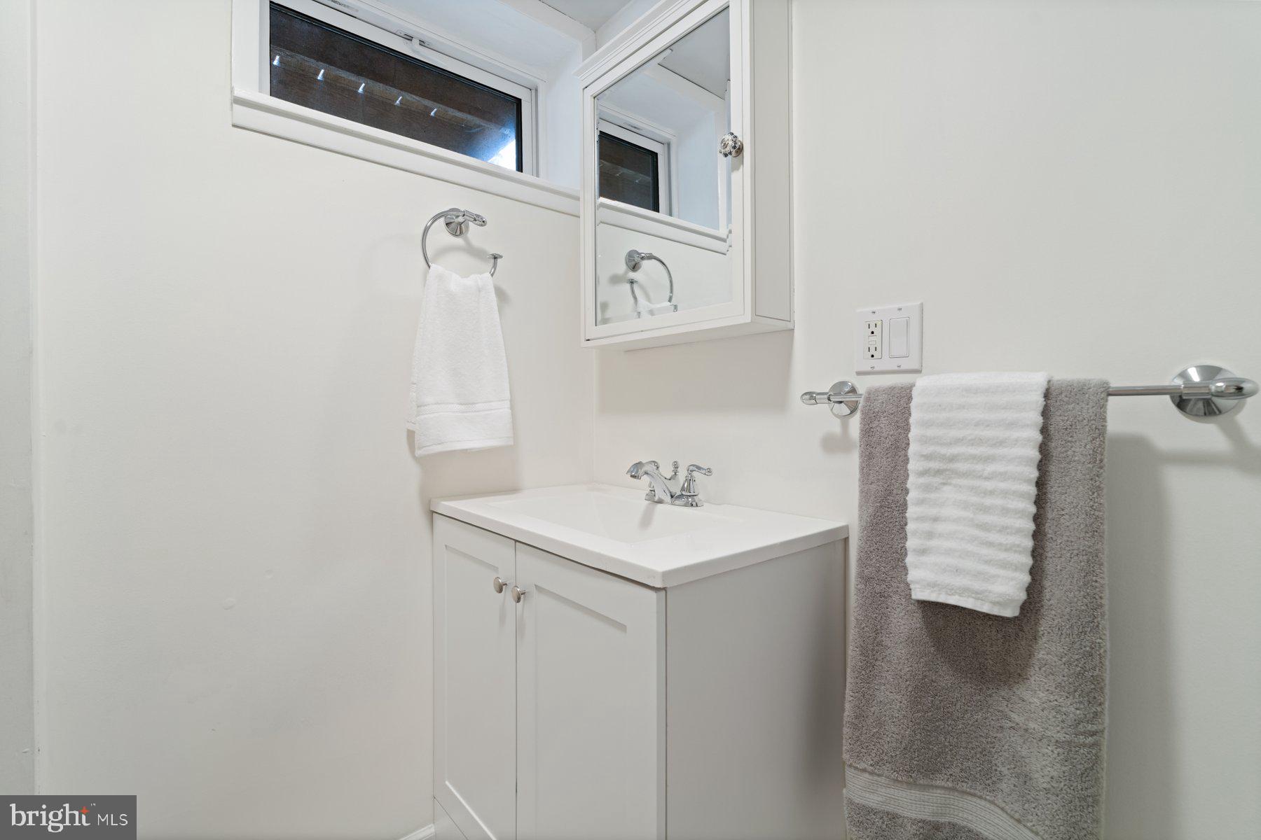 540 Brook Road Towson, MD 21286 - Photo 32 of 37 a bathroom with a sink and a mirror
