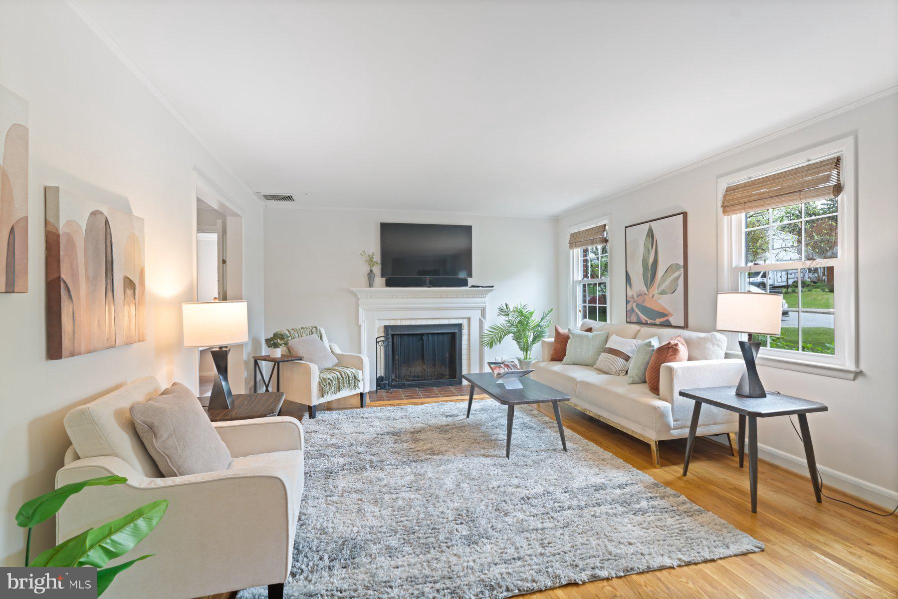 540 Brook Road Towson, MD 21286 - Photo 5 of 37 a living room with furniture a rug a large window and a fireplace