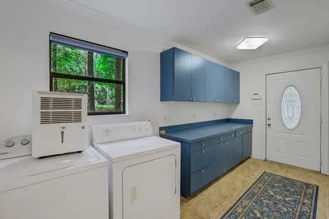 a view of cabinets with washer and dryer