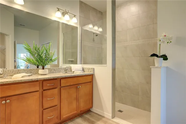 a bathroom with a shower sink and mirror