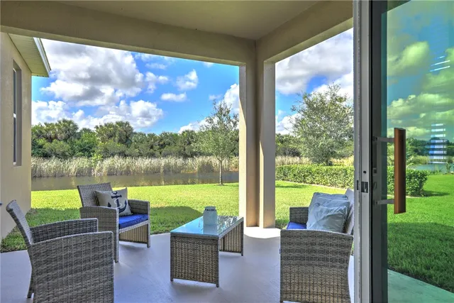 a patio view with a lake view and a couches