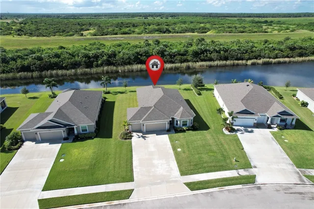 an aerial view of a house with swimming pool and outdoor seating