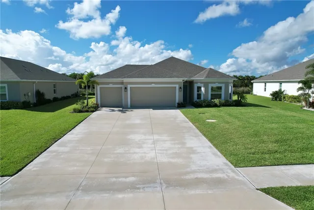 a front view of house with yard and green space