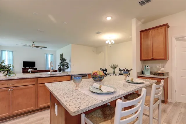 a kitchen with granite countertop a sink and cabinets