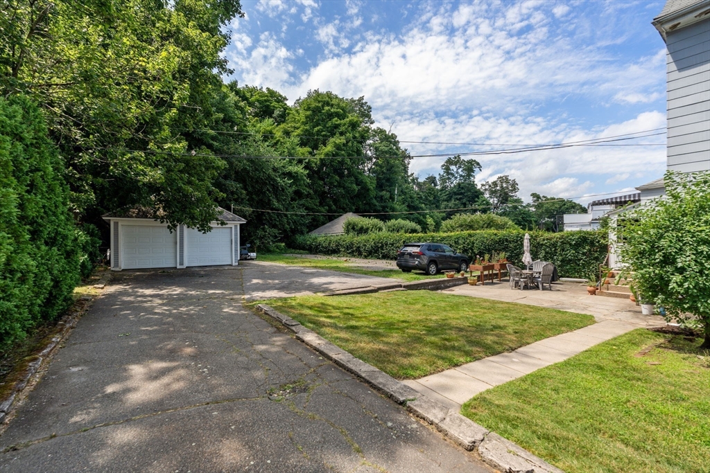 69 Chestnut Hill Avenue Boston, MA 02135 - Photo 3 of 32 a view of a backyard with plants and large trees