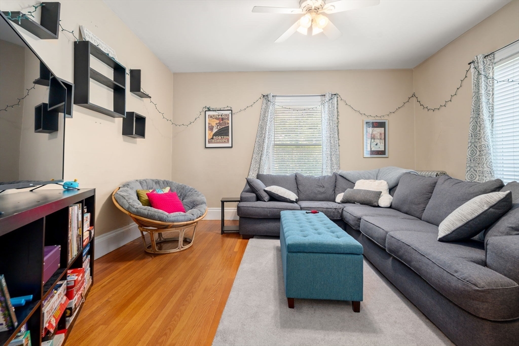 69 Chestnut Hill Avenue Boston, MA 02135 - Photo 8 of 32 a living room with furniture and a wooden floor