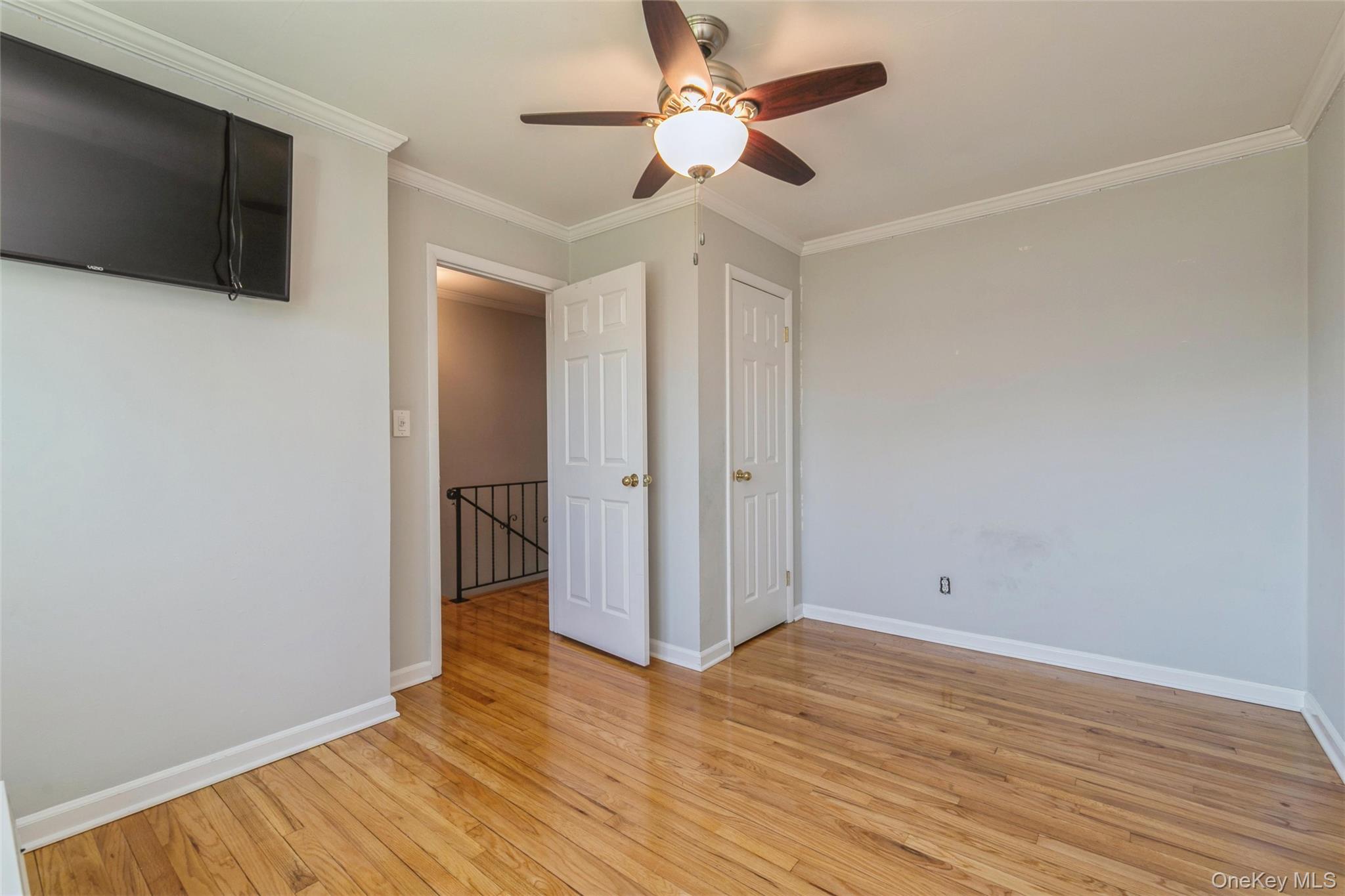 92 Cardinal Lane, Unit 92 Islip, NY 11751 - Photo 11 of 36 a view of an empty room with wooden floor