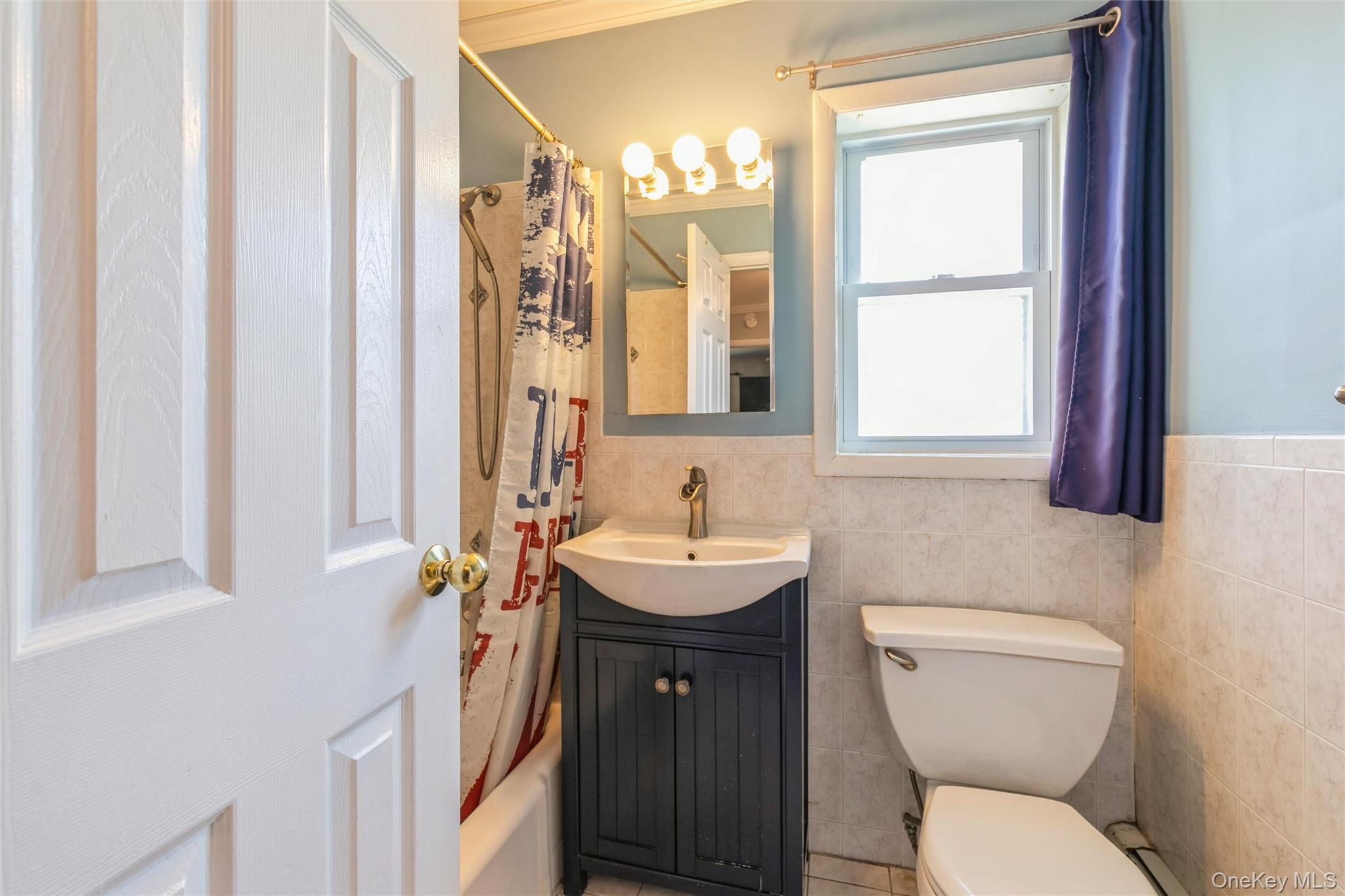 92 Cardinal Lane, Unit 92 Islip, NY 11751 - Photo 13 of 36 a bathroom with a toilet a sink and a mirror