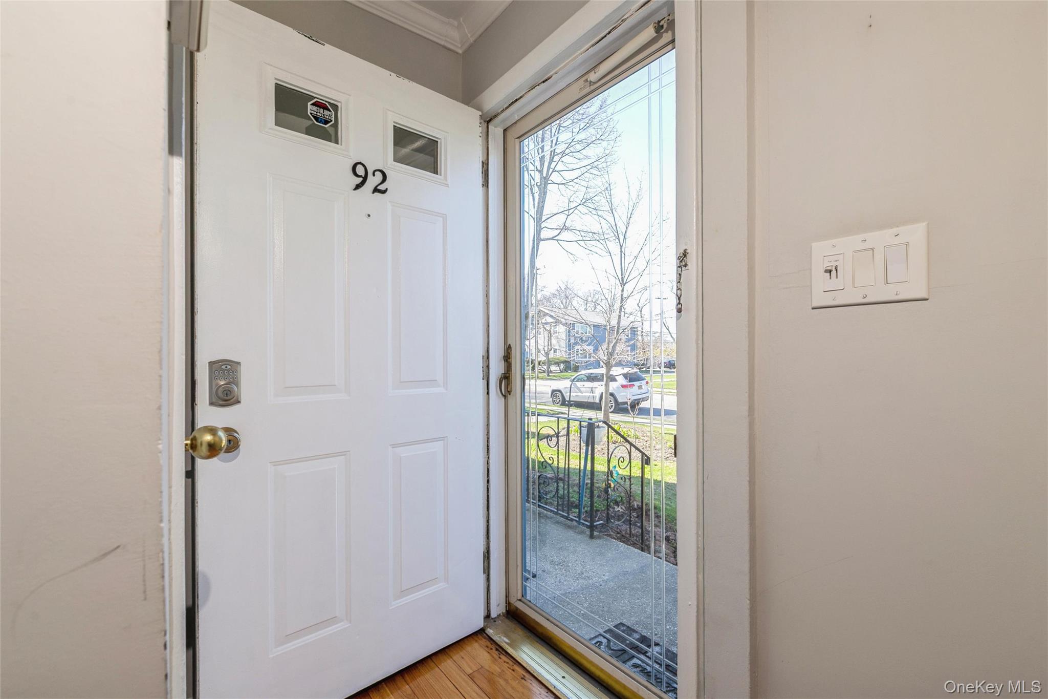 92 Cardinal Lane, Unit 92 Islip, NY 11751 - Photo 15 of 36 a view of a glass door with a bathroom
