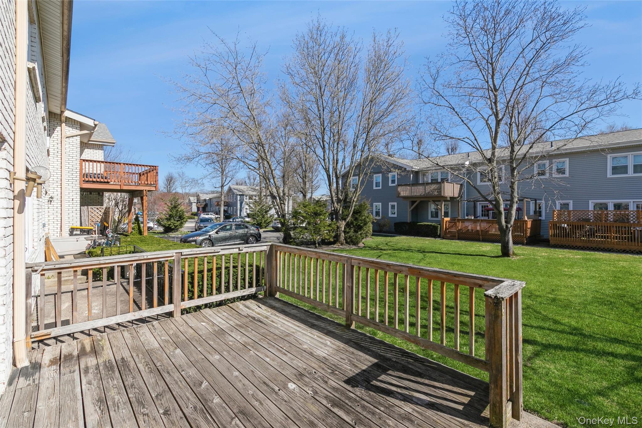 92 Cardinal Lane, Unit 92 Islip, NY 11751 - Photo 17 of 36 a view of a house with a yard and trees