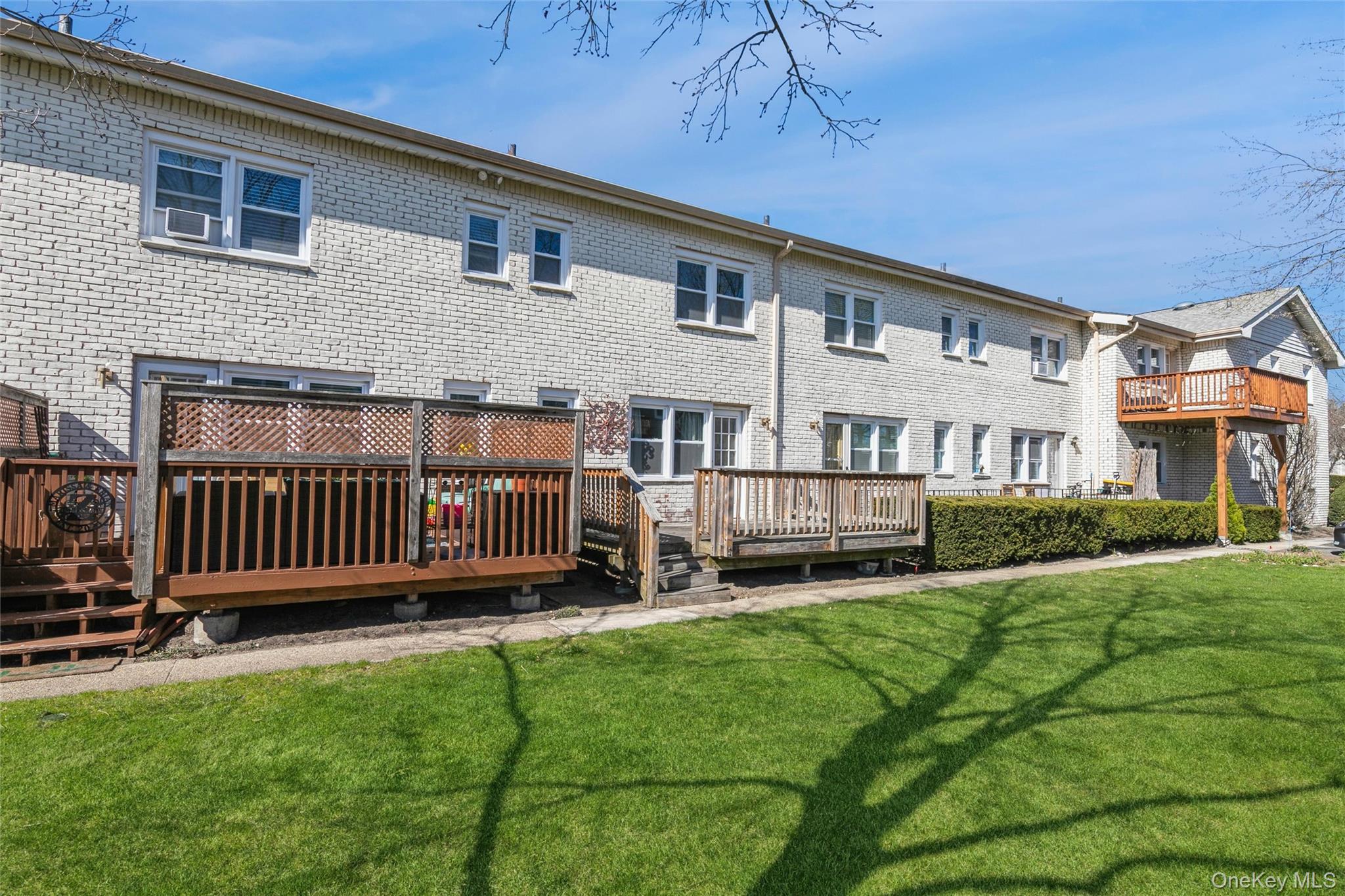 92 Cardinal Lane, Unit 92 Islip, NY 11751 - Photo 21 of 36 a view of a house with a yard and deck