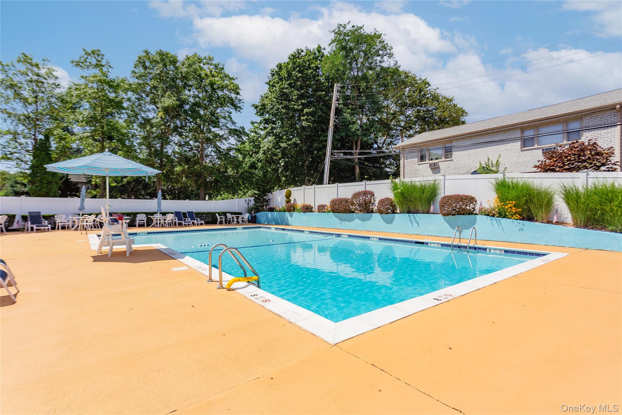 92 Cardinal Lane, Unit 92 Islip, NY 11751 - Photo 29 of 36 a view of swimming pool with chairs
