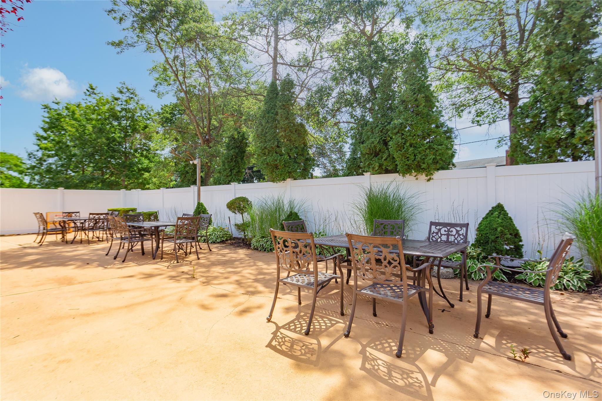 92 Cardinal Lane, Unit 92 Islip, NY 11751 - Photo 31 of 36 an outdoor space with patio and white umbrellas