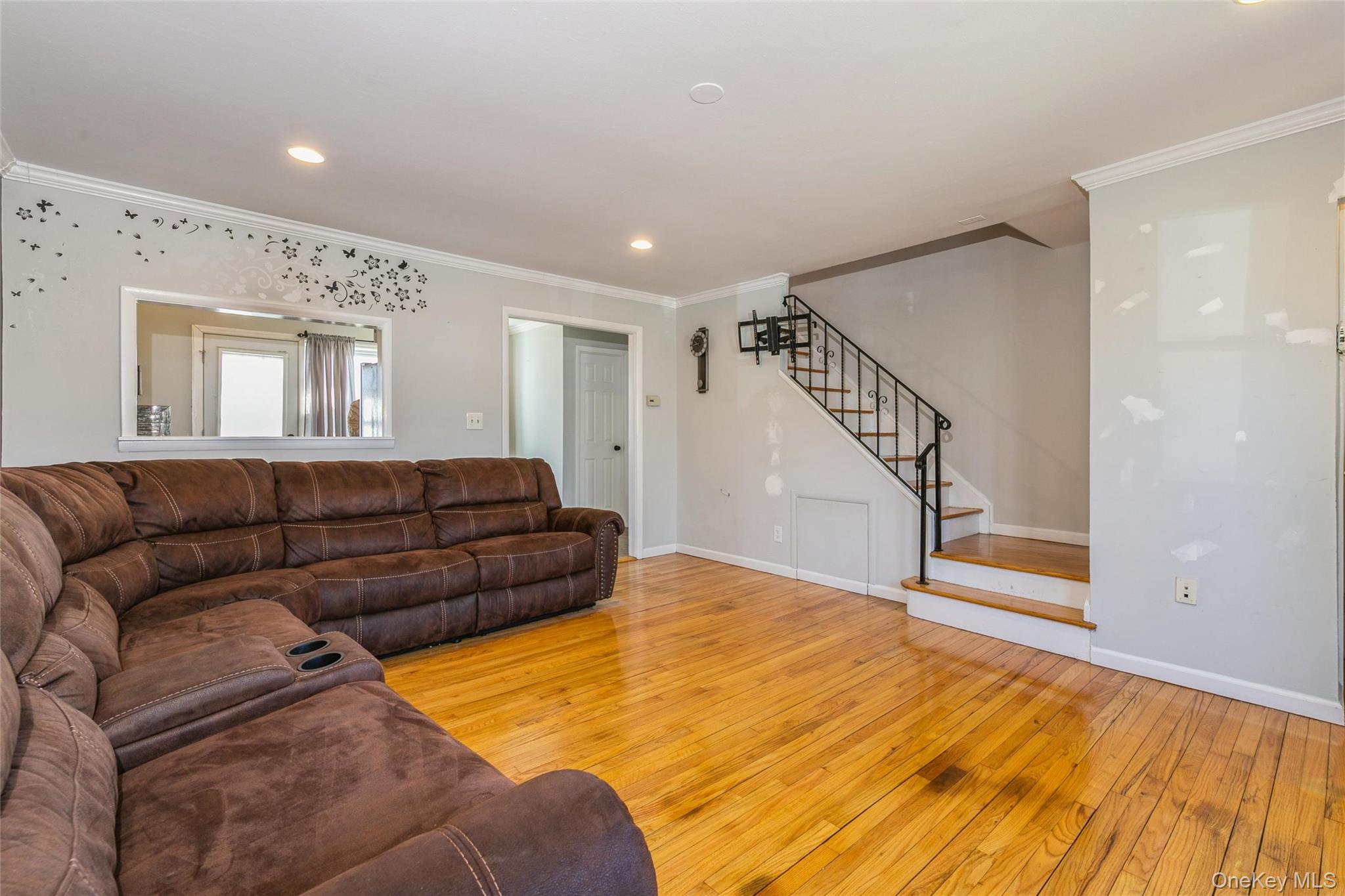 92 Cardinal Lane, Unit 92 Islip, NY 11751 - Photo 4 of 36 a living room with furniture and stairs