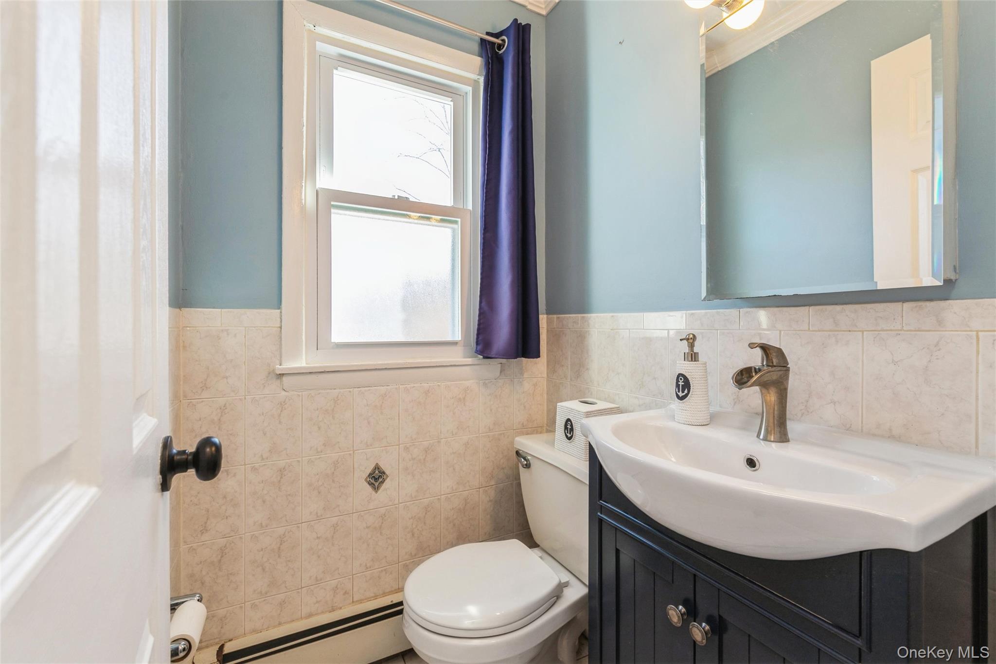 92 Cardinal Lane, Unit 92 Islip, NY 11751 - Photo 8 of 36 a bathroom with a sink a toilet and a window