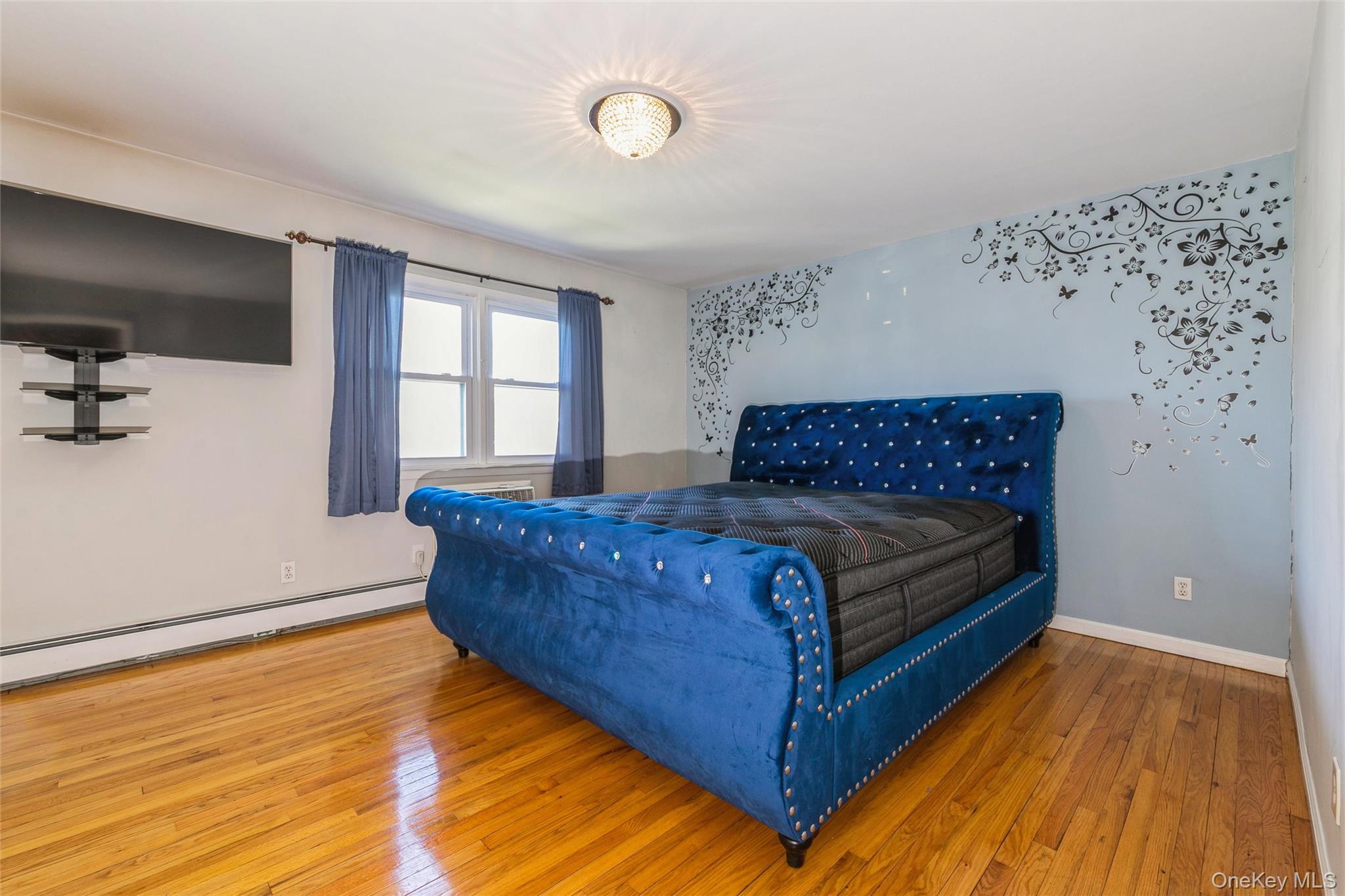 92 Cardinal Lane, Unit 92 Islip, NY 11751 - Photo 9 of 36 a bedroom with a bed and window