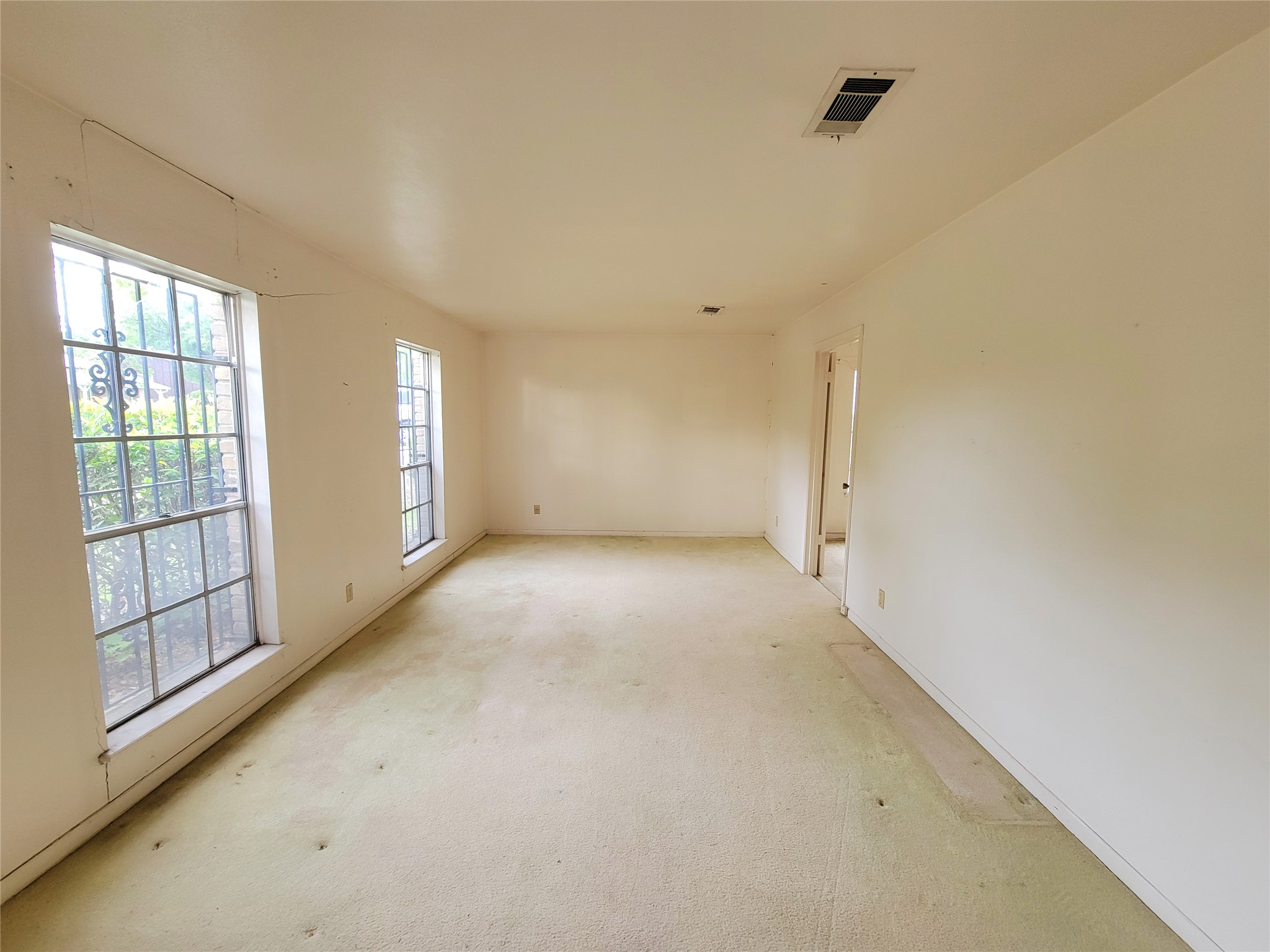 6605 Highpoint Drive Austin, TX 78723 - Photo 3 of 11 Carpeted interior room with multiple windows and white walls