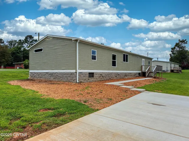 a backyard of a house with lots of green space and outdoor space