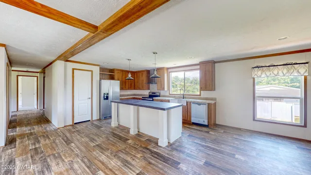 a kitchen with stainless steel appliances granite countertop a stove and a refrigerator