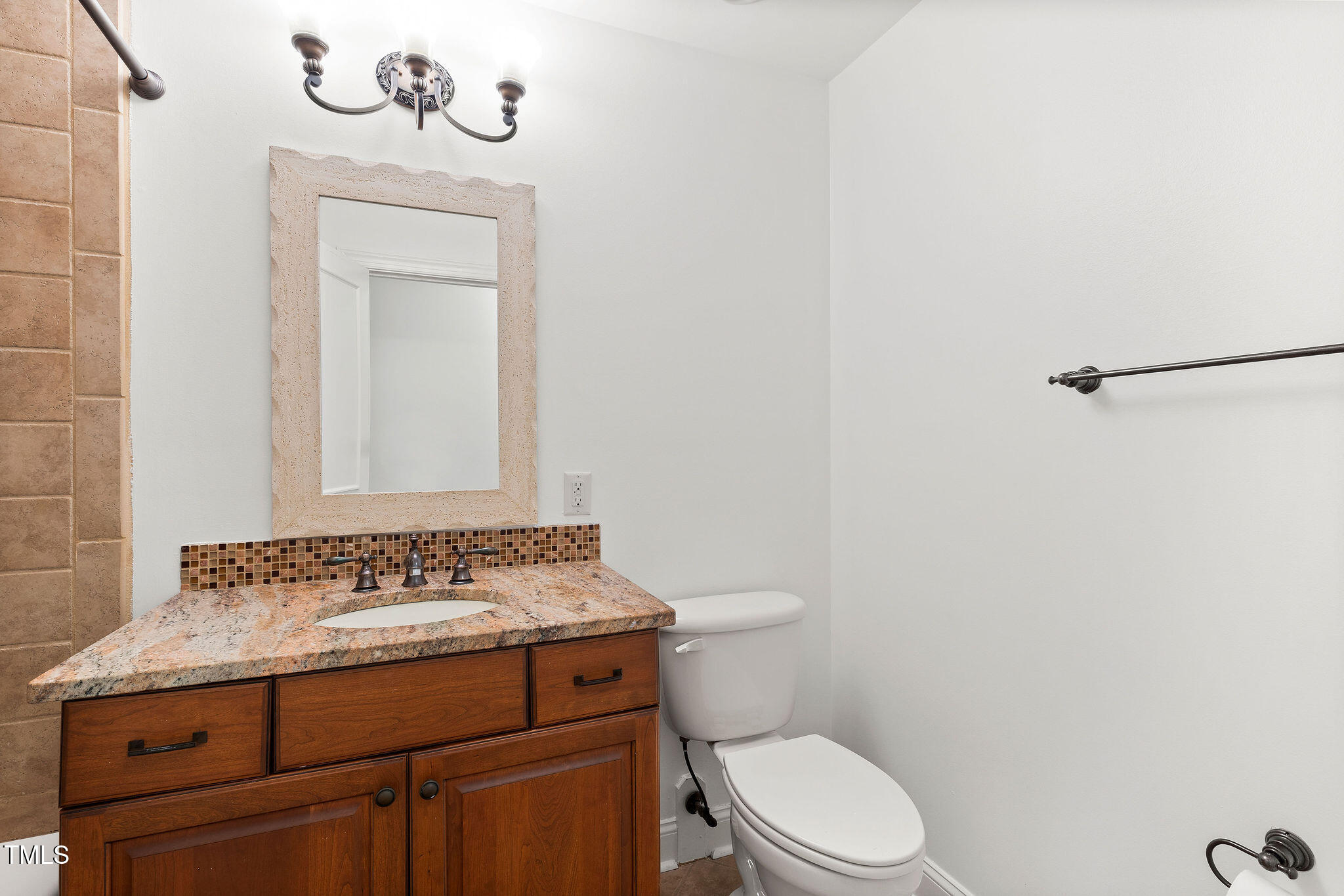 6131 Yellowstone Drive Durham, NC 27713 - Photo 20 of 29 a bathroom with a toilet sink vanity and mirror