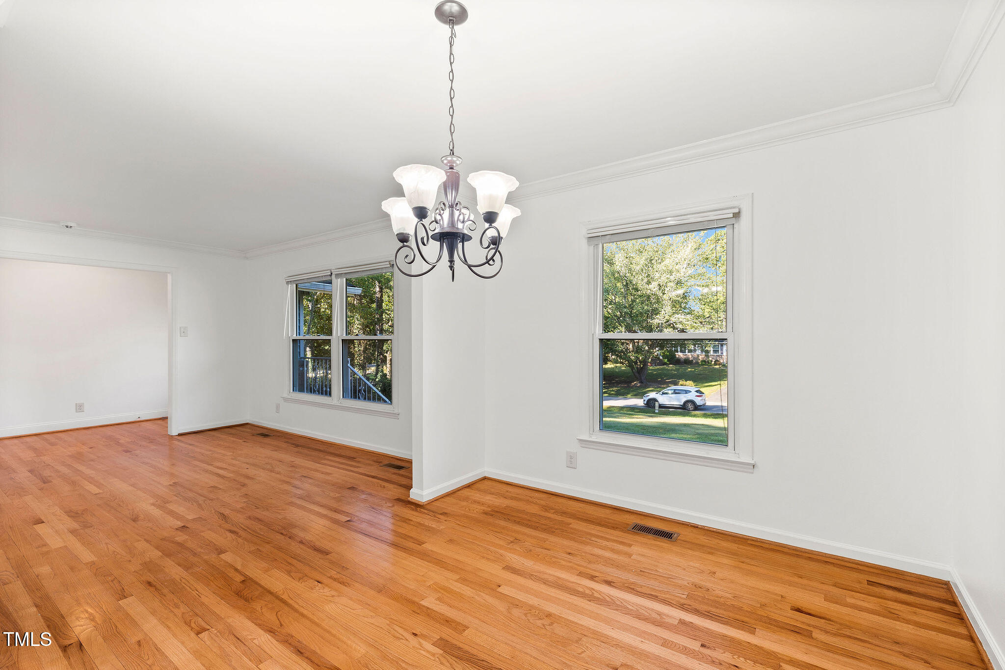 6131 Yellowstone Drive Durham, NC 27713 - Photo 23 of 29 a view of an empty room with wooden floor and a window