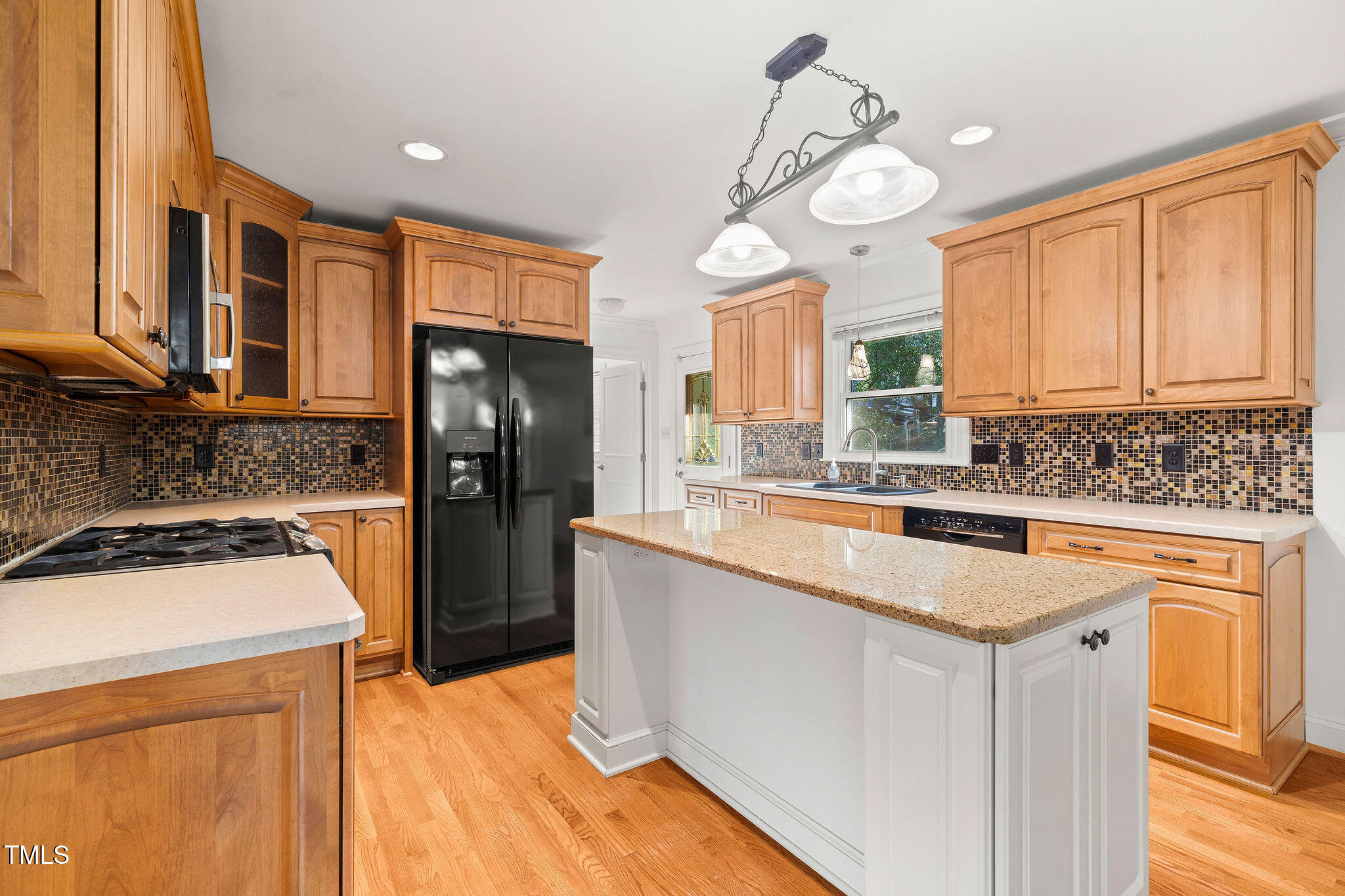 6131 Yellowstone Drive Durham, NC 27713 - Photo 7 of 29 a kitchen with stainless steel appliances granite countertop a sink a stove and a refrigerator