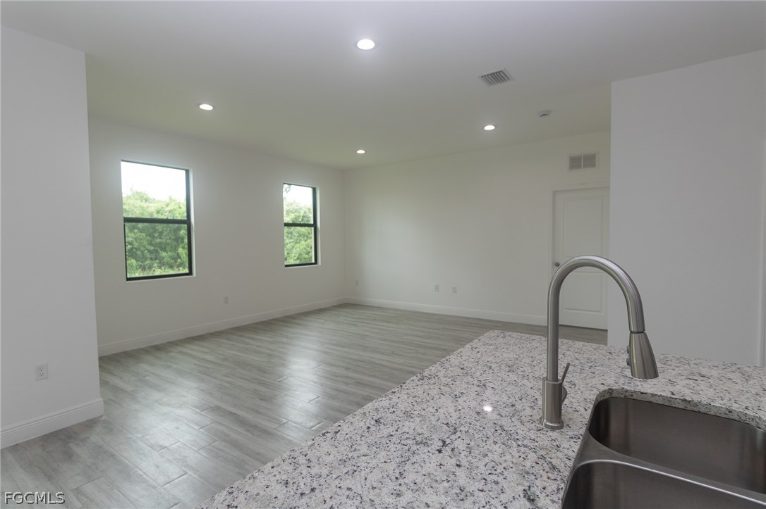 3032 West Briarwood Road LaBelle, FL 33935 - Photo 6 of 23 a view of a kitchen with granite countertop stainless steel appliances and a sink