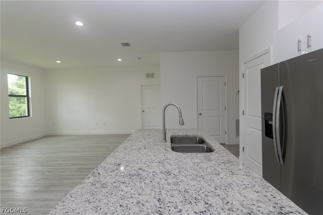 3032 West Briarwood Road LaBelle, FL 33935 - Photo 7 of 23 a view of a refrigerator in kitchen and a window
