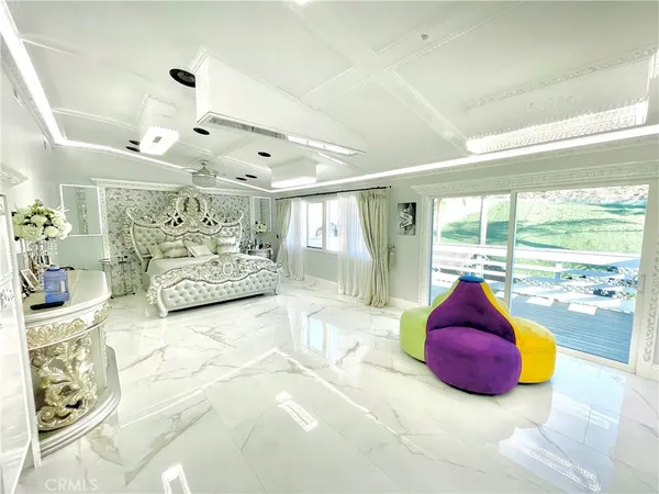 a spacious bedroom with a large bed and a large window