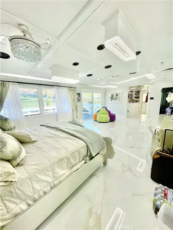 a bedroom with a bed mirror and a window