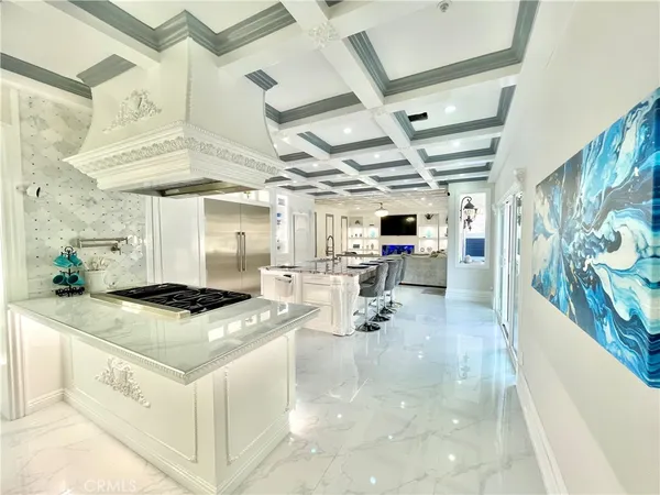 a kitchen with stainless steel appliances granite countertop a sink a stove and a refrigerator