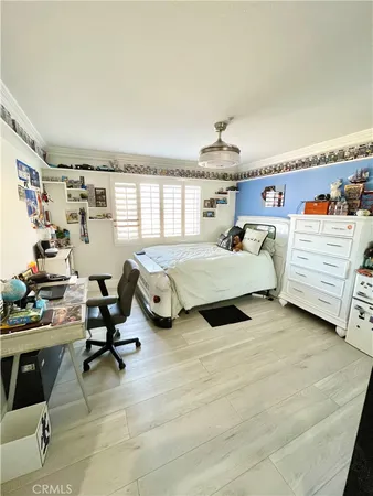 a bedroom with furniture and a large window