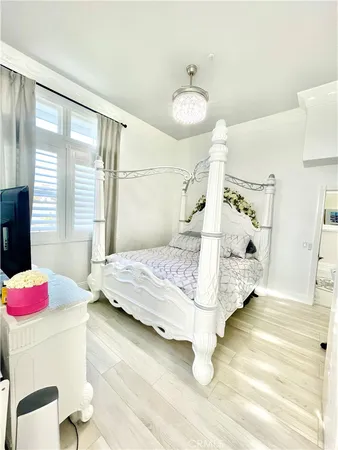 a bedroom with a bed and a chandelier