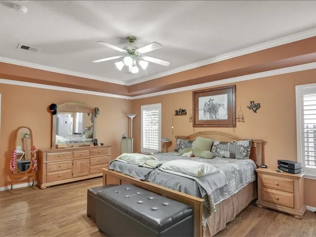 a bedroom with a bed couch and a chandelier