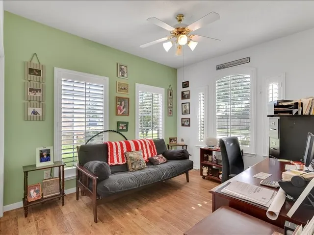 a view of a livingroom with workspace and a couch