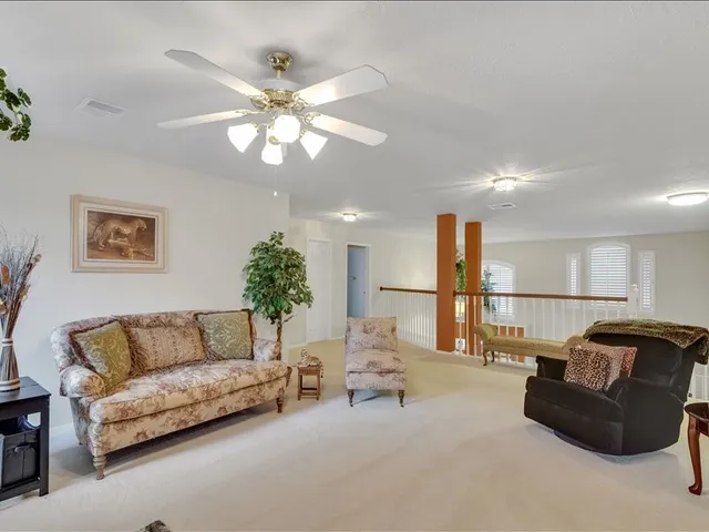 a view of staircase with furniture and window
