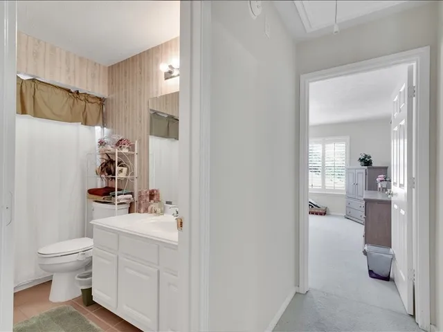 a bedroom with bed and a chandelier