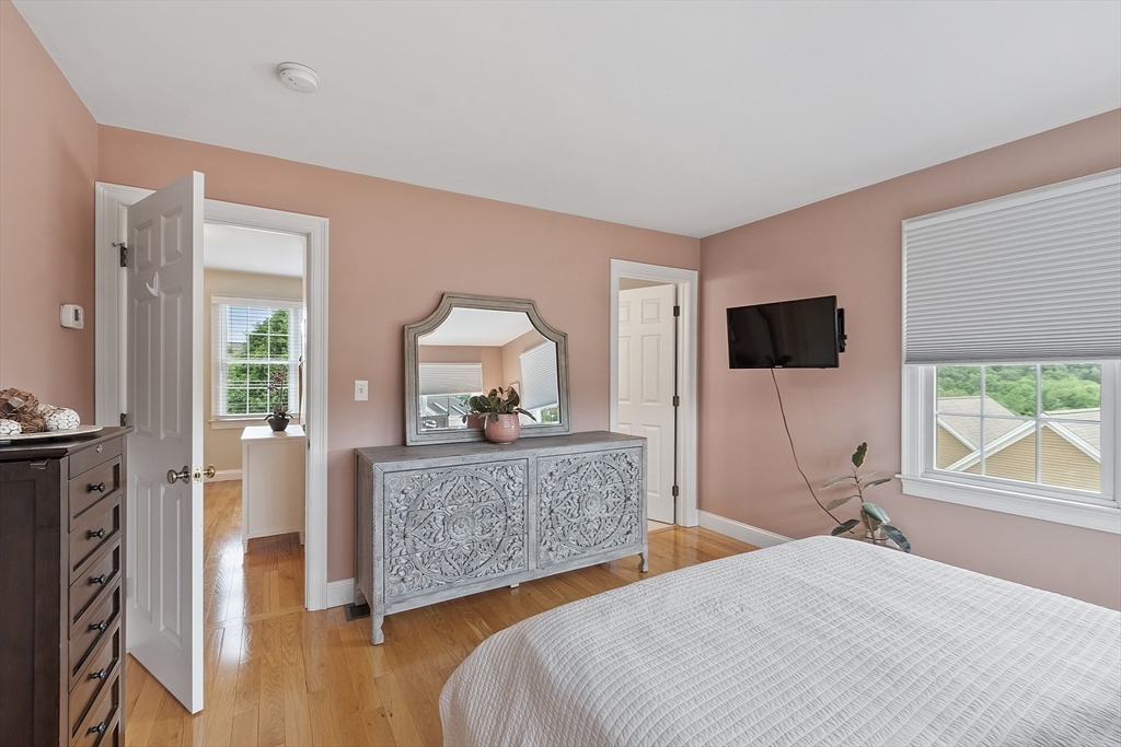 35 Lancaster County Road, Unit 7C Harvard, MA 01451 - Photo 17 of 33 a bedroom with a bed and a flat screen tv