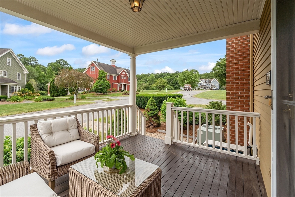 35 Lancaster County Road, Unit 7C Harvard, MA 01451 - Photo 28 of 33 a view of roof deck with couches and wooden floor