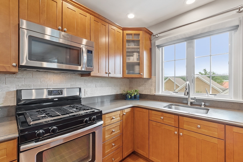 35 Lancaster County Road, Unit 7C Harvard, MA 01451 - Photo 10 of 33 a kitchen with stainless steel appliances a stove microwave and sink