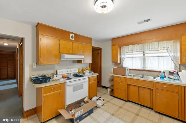 a kitchen with a sink stove and cabinets