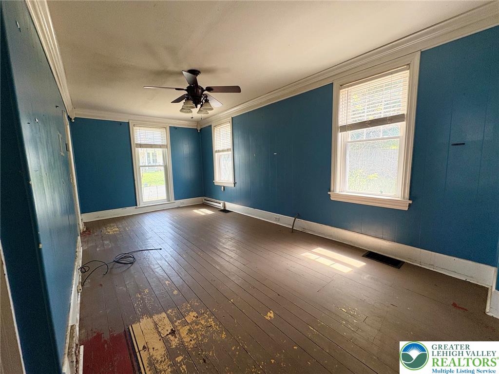 2879 Cemetery Street Slatington, PA 18080 - Photo 11 of 20 an empty room with windows and chandelier fan