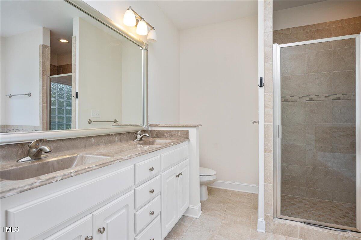 7326 Red Fox Road Bailey, NC 27807 - Photo 15 of 26 a bathroom with a granite countertop sink toilet and shower